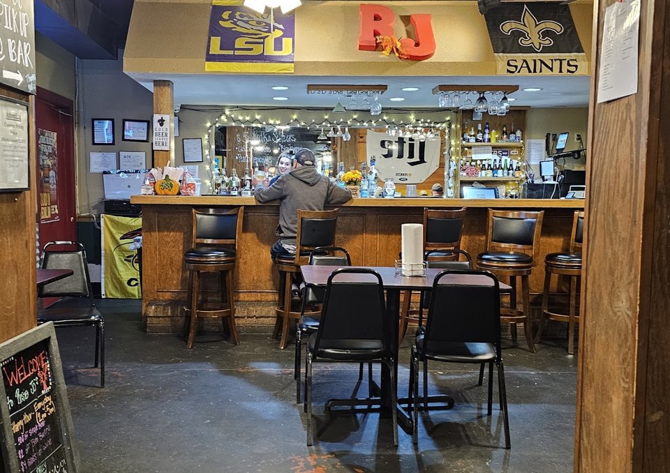 Bar seating beside a restaurant dining area
